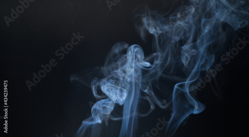 Vintage smoke color movement on black background with copy space.