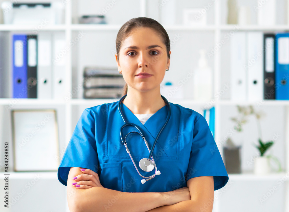 Professional medical doctor working in hospital office, Portrait of young and attractive female physician in protective mask. Professional medical doctor working in hospital office, Portrait of young and attractive female physician in protective mask.