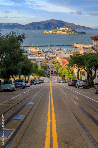 The iconic cable car tracks at the top of Hyde Street, with the famous Alcatraz Island in background in San Francisco, California, USA © SvetlanaSF