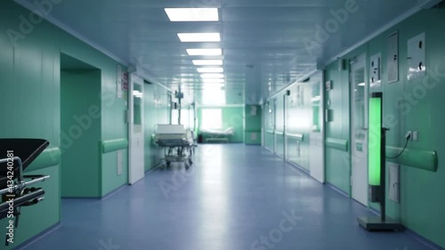 Automatic doors to the operating room open. Empty hospital corridor with couches 