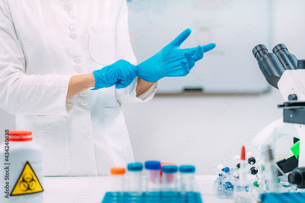 Putting On Protective Gloves. Laboratory Safety Equipment. Putting On Protective Gloves. Laboratory Safety Equipment.