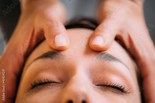 CST therapist Massaging Woman’s Head. Craniosacral Therapy Massage. photo