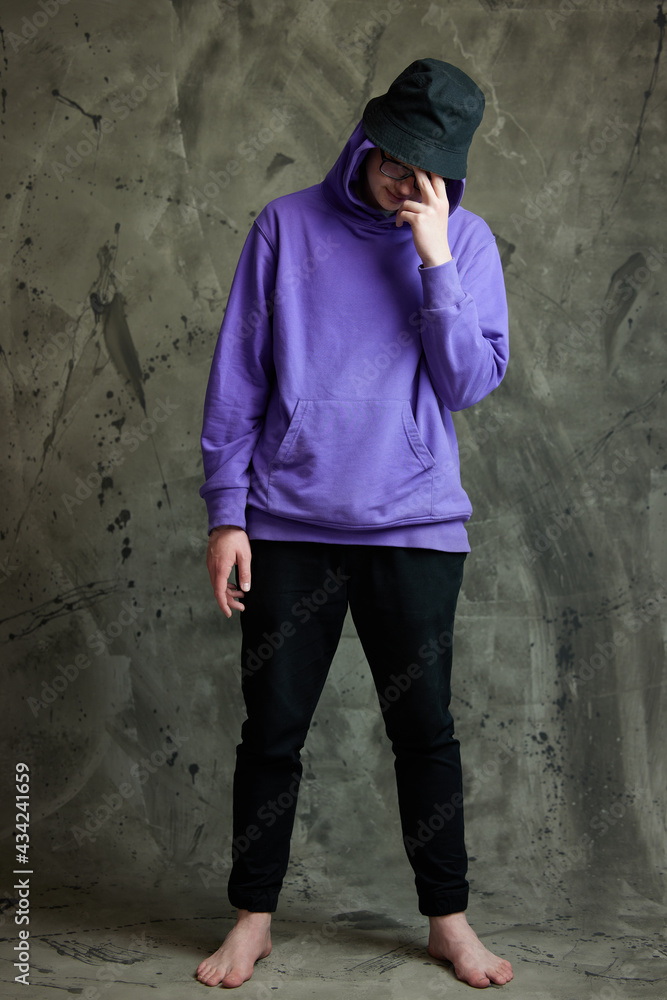 Horizontal portrait of a stylish caucasian guy in full growth on a gray background Horizontal portrait of a stylish caucasian guy in full growth on a gray background