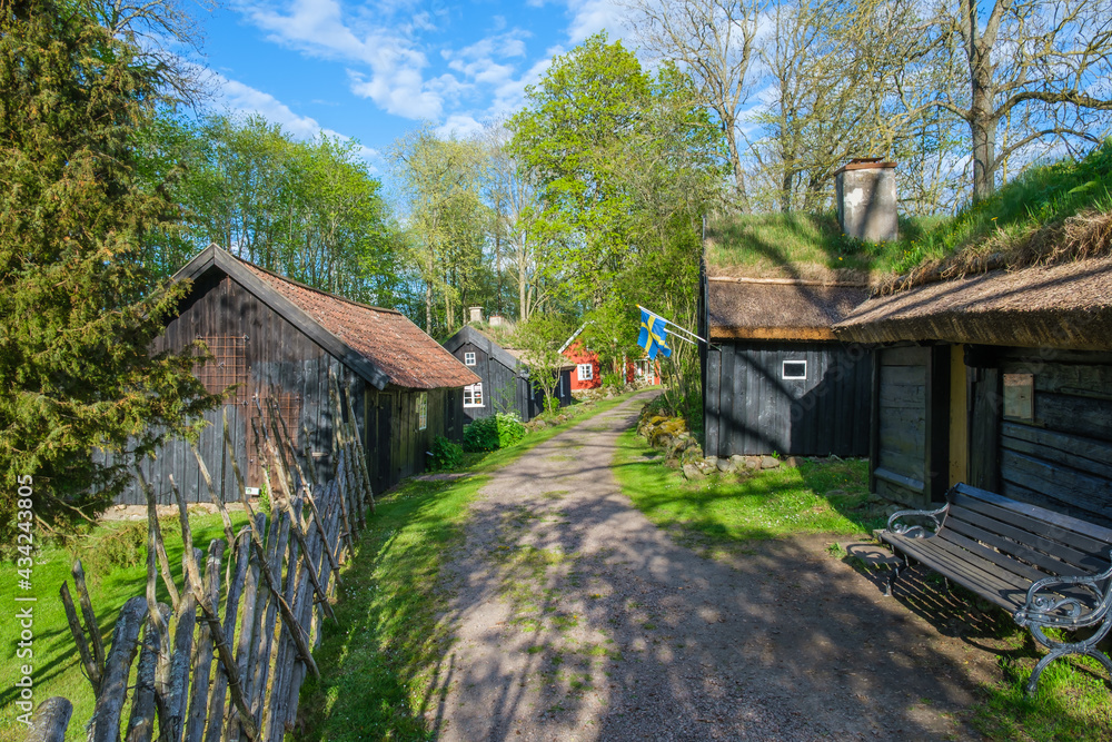 Fototapeta premium Old settlement with log house at Åsle tå in Sweden