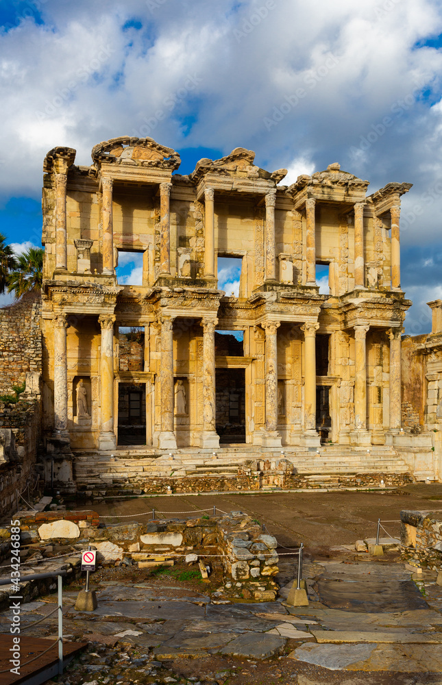 Remained reconstructed facade of Library of Celsus at ruins of ancient Greek city of Ephesus on sunny day, Turkey