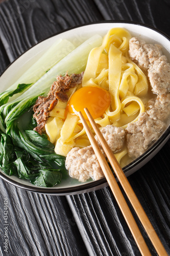 Ban Mian Minced Pork Noodle Soup Handmade closeup in the bowl on the table. Vertical photo