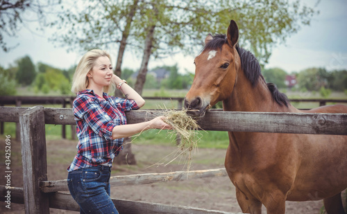 Woman enjoying horse company. Mature Beautiful With Horse Outdoors, stylish lady at countryside