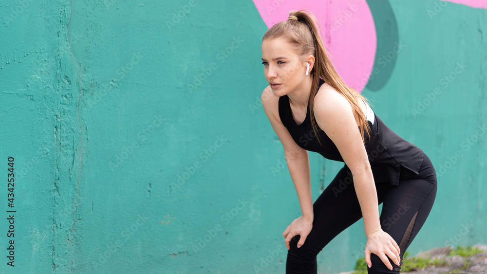 Fototapeta premium Young focused blonde woman at outdoors training