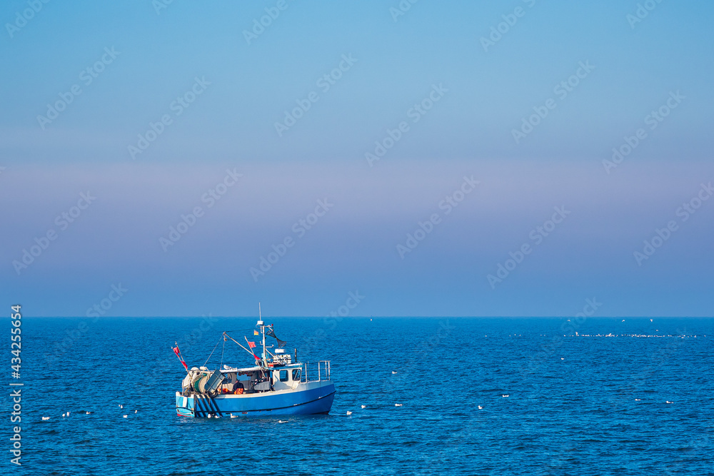 Fischerboot mit Möwen auf der Ostsee vor Warnemünde