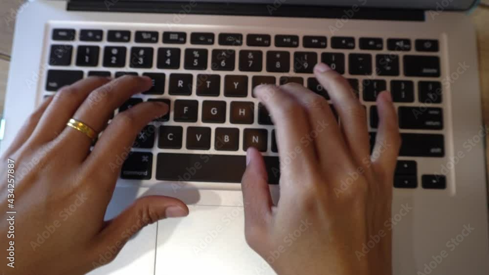 Working on computer. Top view of hands typing something on computer keyboard Working on computer. Top view of hands typing something on computer keyboard