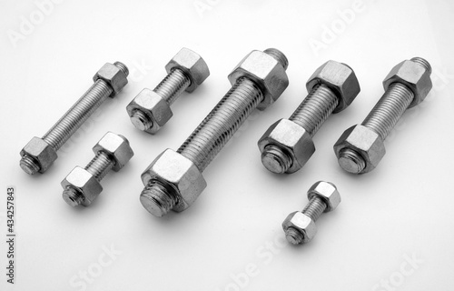 large metal screws with bolts forming a diagonal texture

