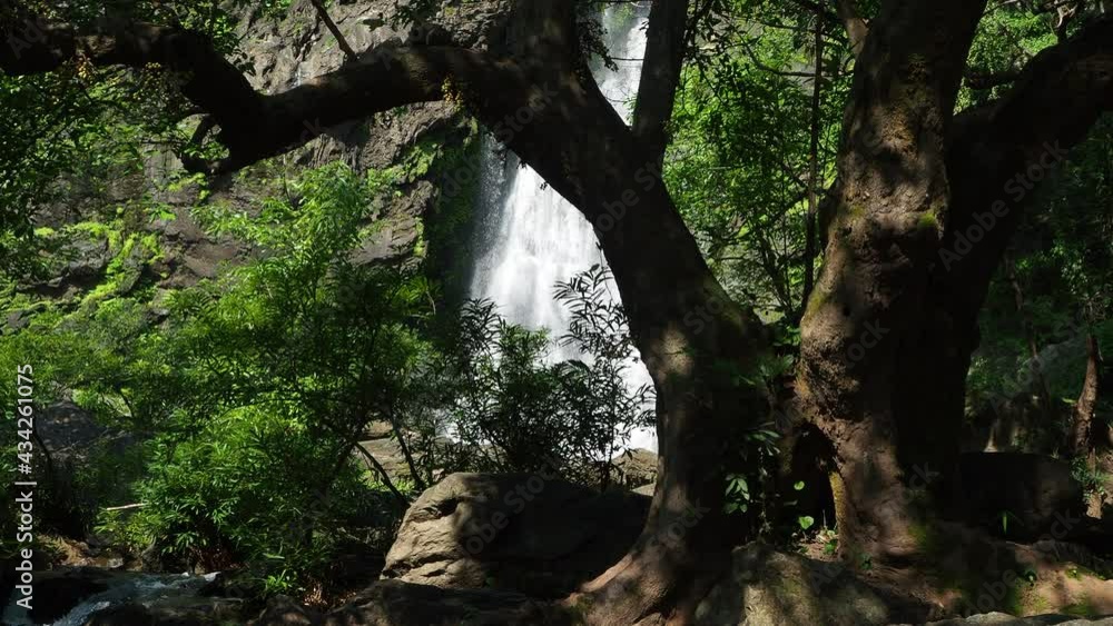 landscape with flowing water of Khlong Lan waterfall in Kamphaeng Phet province at deep tropical rain forest. Khlong Lan National Park, Thailand landscape with flowing water of Khlong Lan waterfall in Kamphaeng Phet province at deep tropical rain forest. Khlong Lan National Park, Thailand