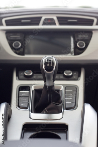 New modern unknown car with manual transmission. Modern transportation. Themed blur background.