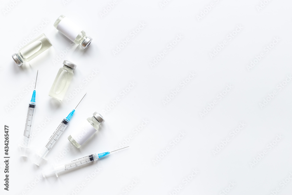 Covid vaccine in bottles with syringe. Top view Covid vaccine in bottles with syringe. Top view