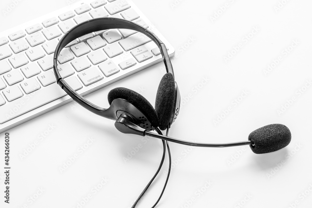 Communication support call center. Voip headset and computer laptop, top view Communication support call center. Voip headset and computer laptop, top view