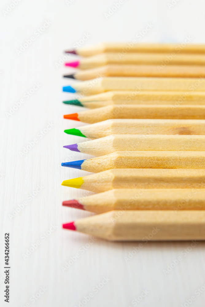 Obraz premium Pastel tips of various colors, on a light wooden surface. Design and colors. 