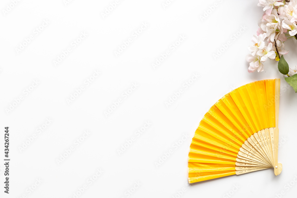 Asian background with hand fan and blossom branches