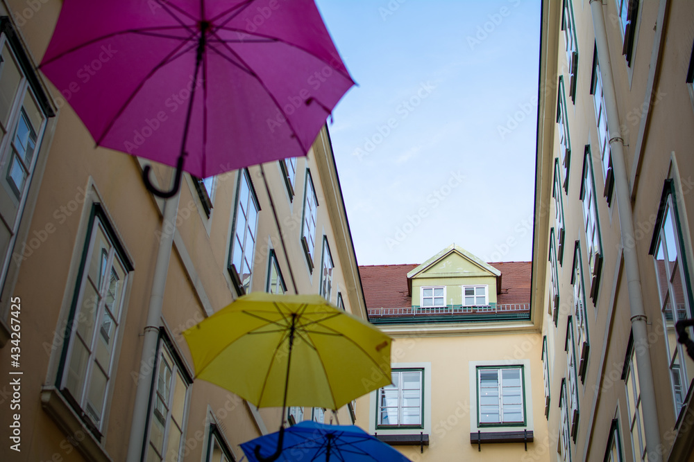 Umbrellas with different colors hanging in the  Courtyard and public passage Suennhof in the 3rd District in Vienna, Austria 