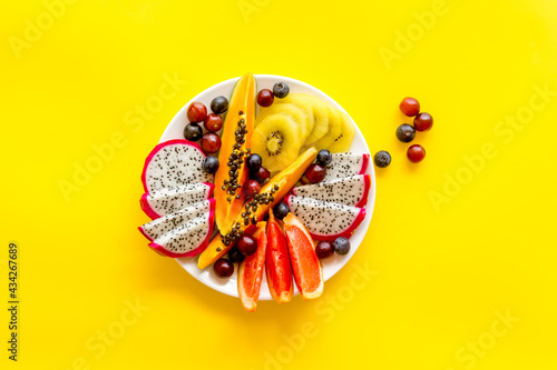 Exotic fruit dish with dragon fruit and papaya, top view