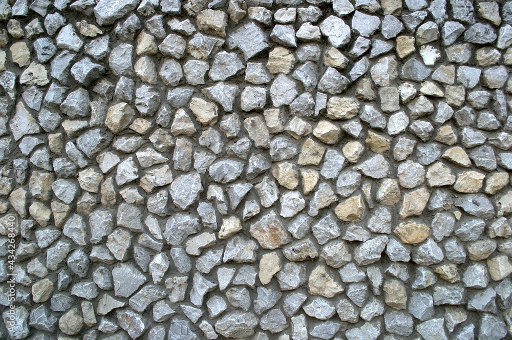 A wall of stones. The stones are carefully laid out in a mosaic. A wall of stones. The stones are carefully laid out in a mosaic.