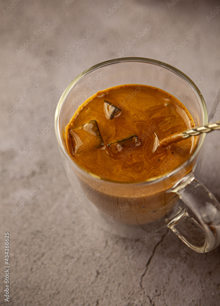 Iced Dalgona coffee drink on wooden tray background. Instant coffee or espresso powder whipped with sugar and hot water. Coffee with milk latte, cappuccino. Two glass cups with double walls. Breakfast Iced Dalgona coffee drink on wooden tray background. Instant coffee or espresso powder whipped with sugar and hot water. Coffee with milk latte, cappuccino. Two glass cups with double walls. Breakfast
