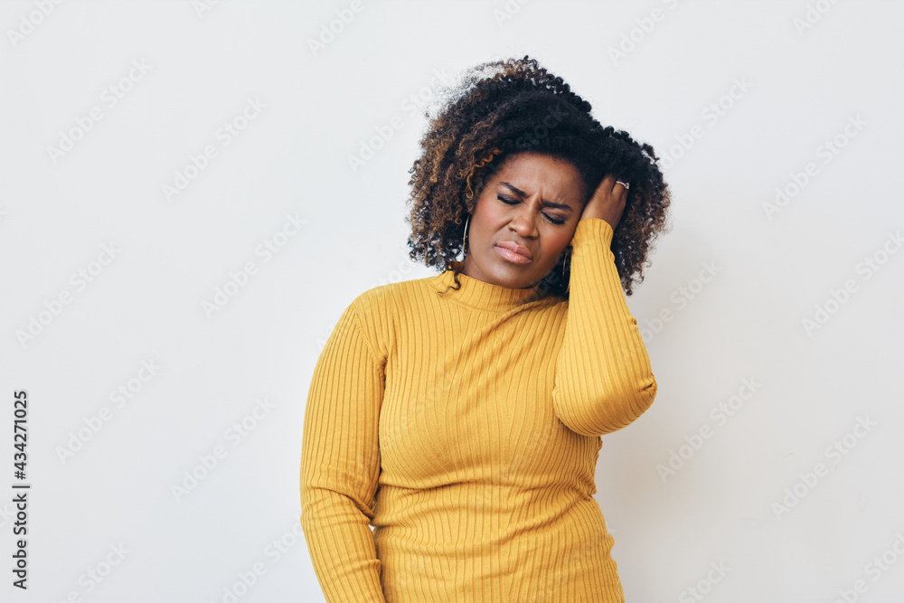 Stressed Mid aged Woman with hand in hair struggling through the headache Stressed Mid aged Woman with hand in hair struggling through the headache