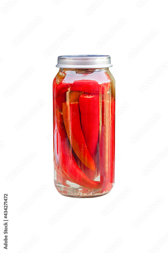 Chili peppers in a glass jar, homemade pickles Chili peppers in a glass jar, homemade pickles