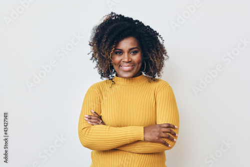 Portrait of smiling beautiful African American woman standing with arms crossed