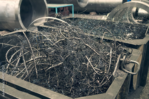 Obraz na plátně Metal shavings or scrap metal waste steel for recycling in container in factory