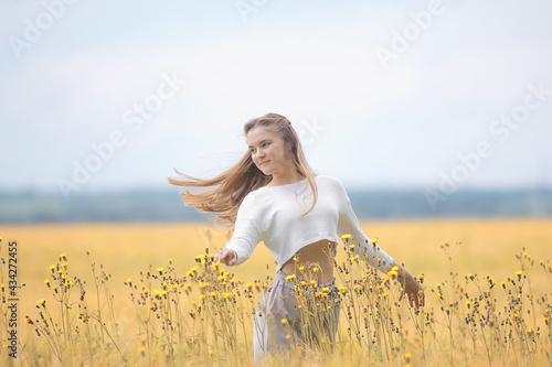 autumn field girl health / beautiful young model, landscape in a summer field, cute happy model