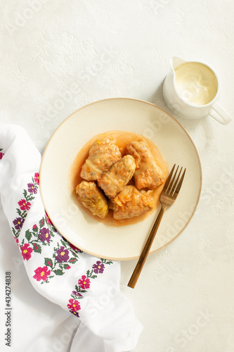 National Ukrainian cuisine dish Golubtsy served with sour cream, top-down view photo