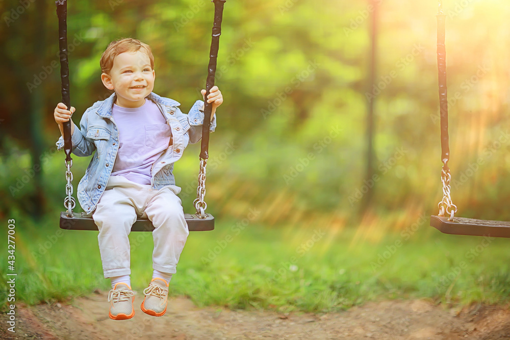 springtime, a boy in the spring swinging on a swing, leisure enjoyment childhood summer happy child springtime, a boy in the spring swinging on a swing, leisure enjoyment childhood summer happy child