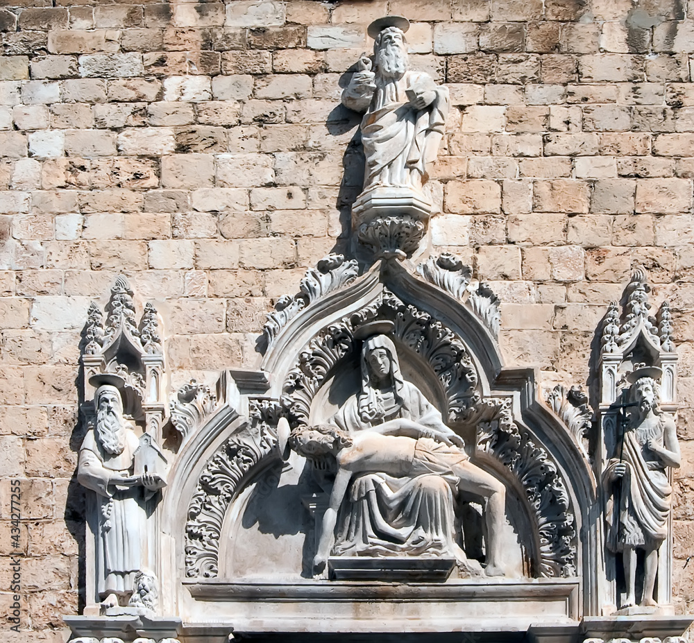 Obraz premium Carved portal from 1498 of Franciscan friary and church in Dubrovnik, Croatia