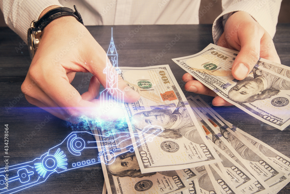 Multi exposure of creative drawing hologram and USA dollars bills and man hands. Start up concept Multi exposure of creative drawing hologram and USA dollars bills and man hands. Start up concept