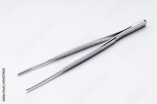 medical tweezers isolated on white background. surgery pincers cut out