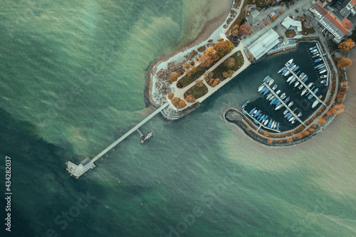 Drone shot of the harbour in Immenstaad Lake of Constace with blue water at the autumn time photo