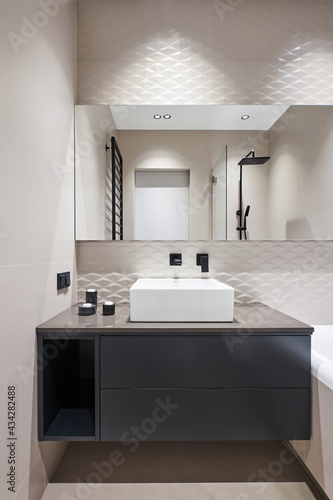 White square ceramic sink in a monochrome minimalist bathroom