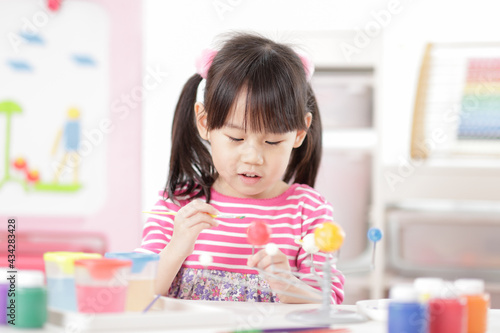 young girl making craft for homeschooling