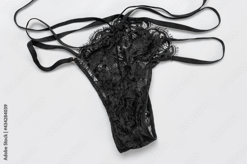 Lace sexy black womens underwear on gray background flat lay top