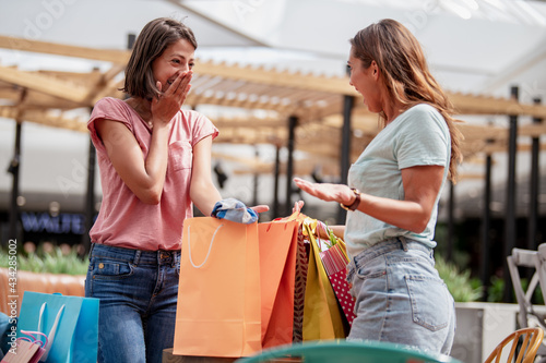 Two young women with shopping bags