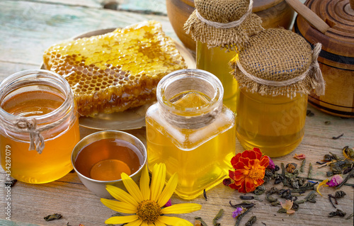 Sweet honey with flowers on an old background.