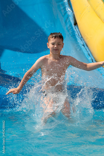 boy jumping into an inflatable pool. Active summer vacation