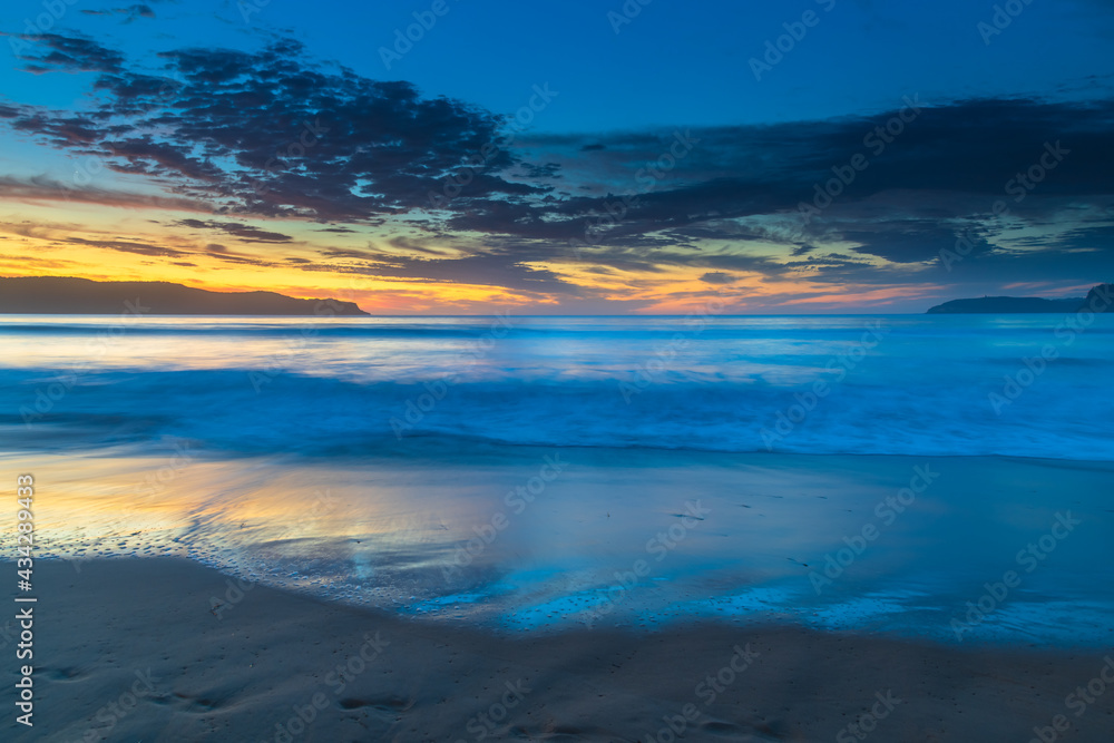 Pretty blue summer sunrise seascape with high cloud