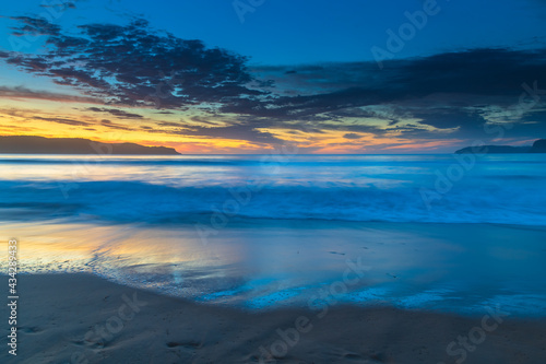 Pretty blue summer sunrise seascape with high cloud © Merrillie