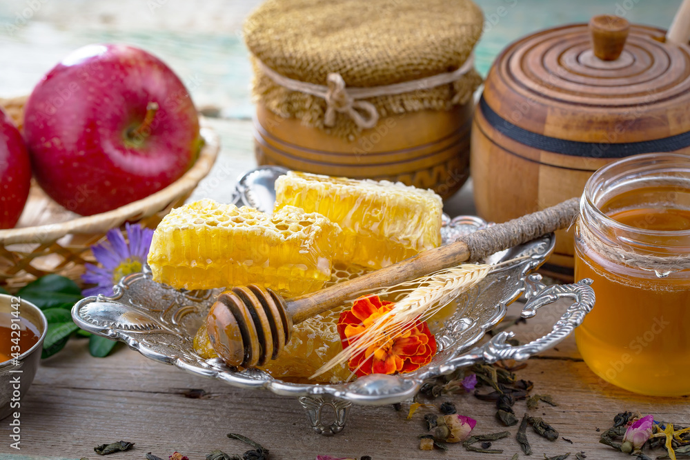 Sweet honey with flowers on an old background. Sweet honey with flowers on an old background.