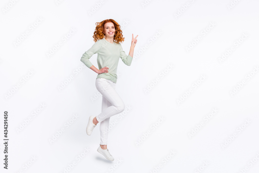 Fototapeta premium Full length body size photo young woman red hair jumping high showing v-sign isolated white color background