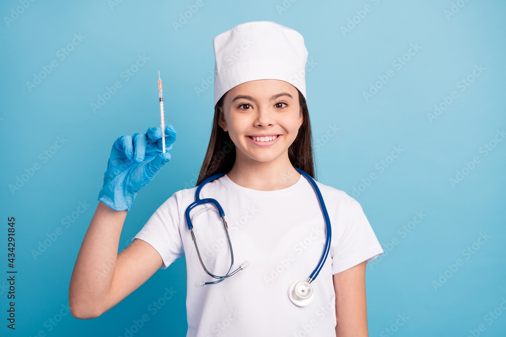Photo portrait of small nurse in medical gloves keeping surgeon before injection isolated bright blue color background Photo portrait of small nurse in medical gloves keeping surgeon before injection isolated bright blue color background