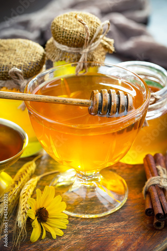 Sweet honey with flowers on an old background.