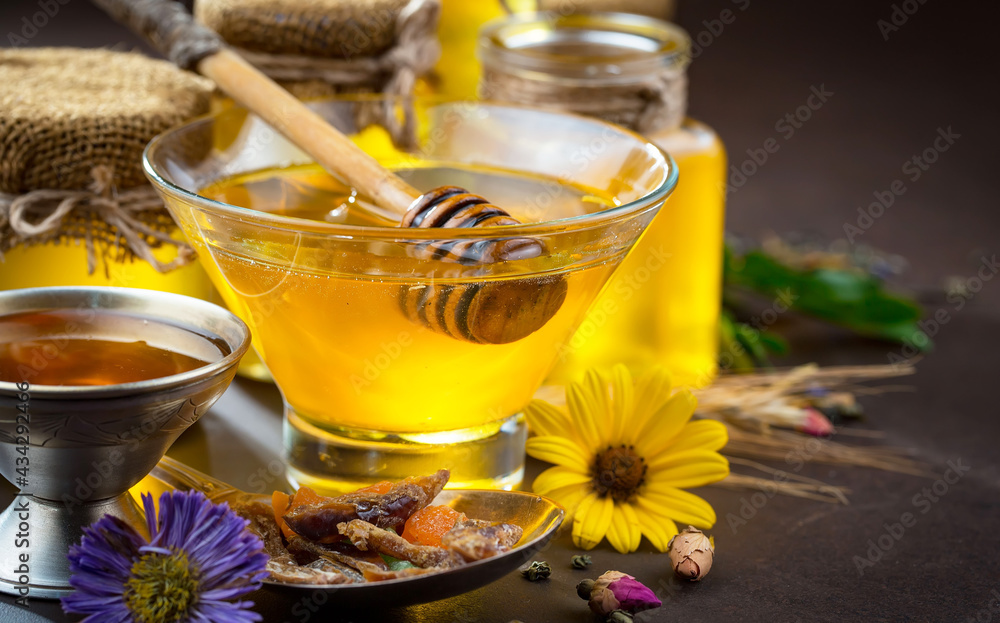 Sweet honey, with kitchen accessories in the composition on the table. Sweet honey, with kitchen accessories in the composition on the table.
