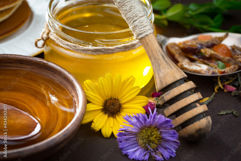 Sweet honey with flowers on an old background. Sweet honey with flowers on an old background.